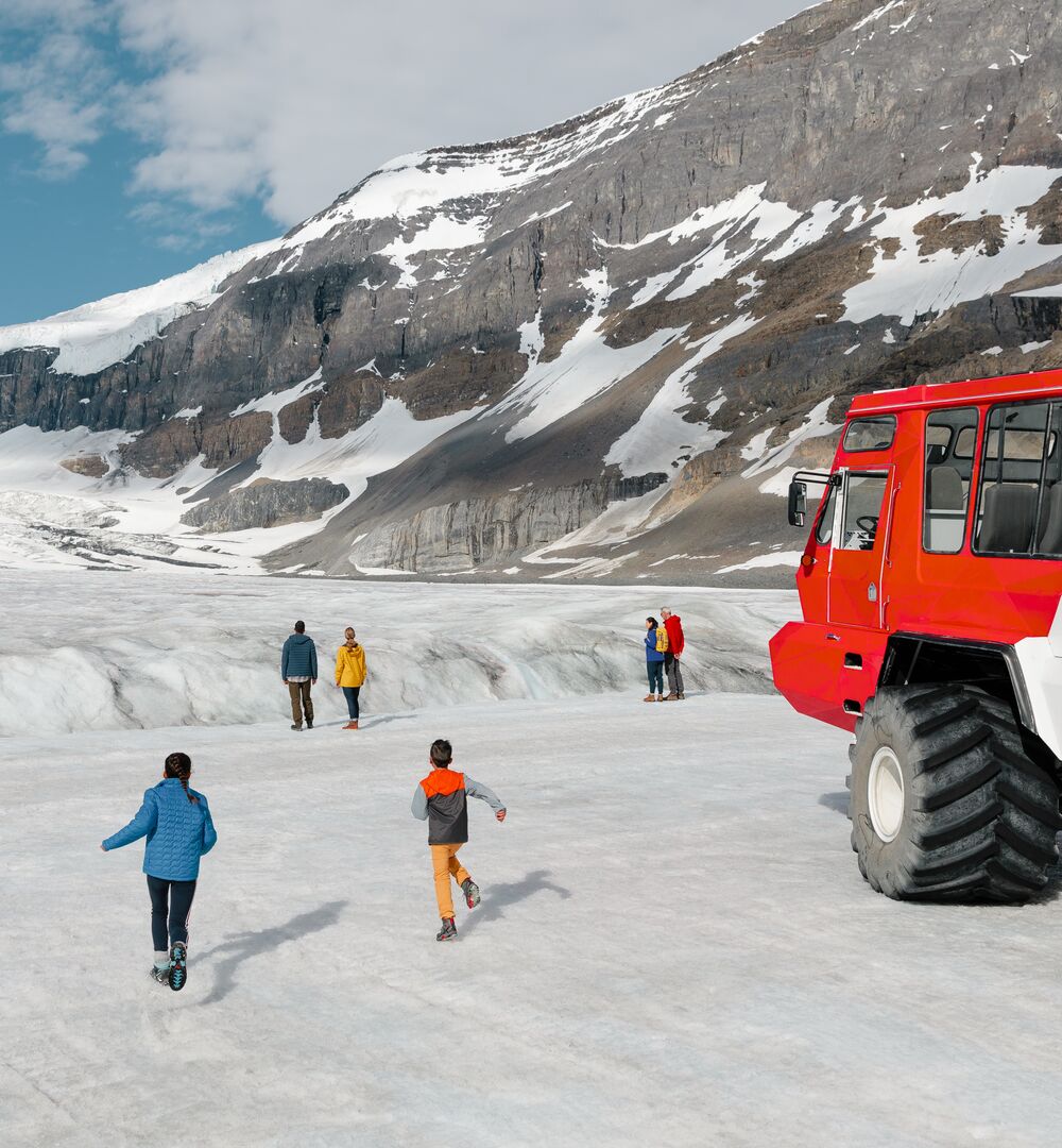 Family exploring the Athabasca Glacier on the Columbia Icefield Adventure